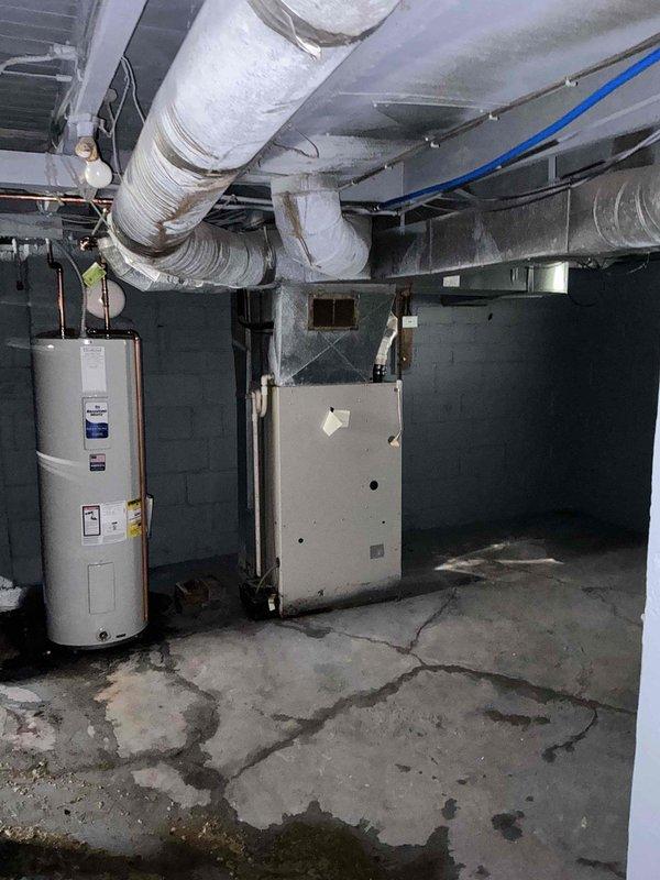 Completed HVAC system evaluation for non-cooling air conditioning unit. Assessed aged outdoor condenser unit showing significant wear and weathering, along with indoor furnace equipment in basement mechanical room. Provided comprehensive replacement estimate for complete system upgrade due to equipment age and condition.