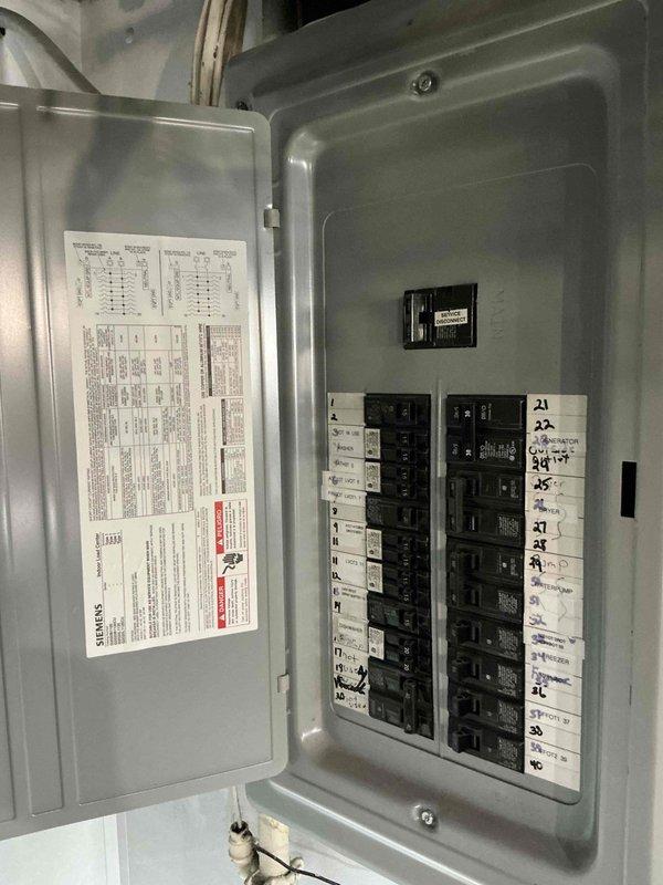 Conducted on-site evaluation for mini split installation on third floor location. Assessed existing electrical panel capacity and circuit availability to determine feasibility for new mini split system power requirements. Documented electrical panel configuration showing adequate breaker positions and load capacity for proposed 9,000 BTU mini split unit installation.