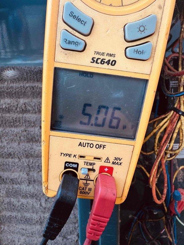 Responded to no-cooling call on 10-year-old Trane outdoor unit. Upon arrival, confirmed thermostat was functioning properly but AC system would not start. Performed diagnostic testing using digital multimeter to check electrical components and measured amperage draw at 5.06 amps and capacitance reading of 0.62 microfarads. Identified failed run capacitor as root cause preventing compressor from starting. Replaced defective capacitor with manufacturer-specified component, restored power to unit, and verified proper system operation with normal amperage readings and cooling cycle initiation.