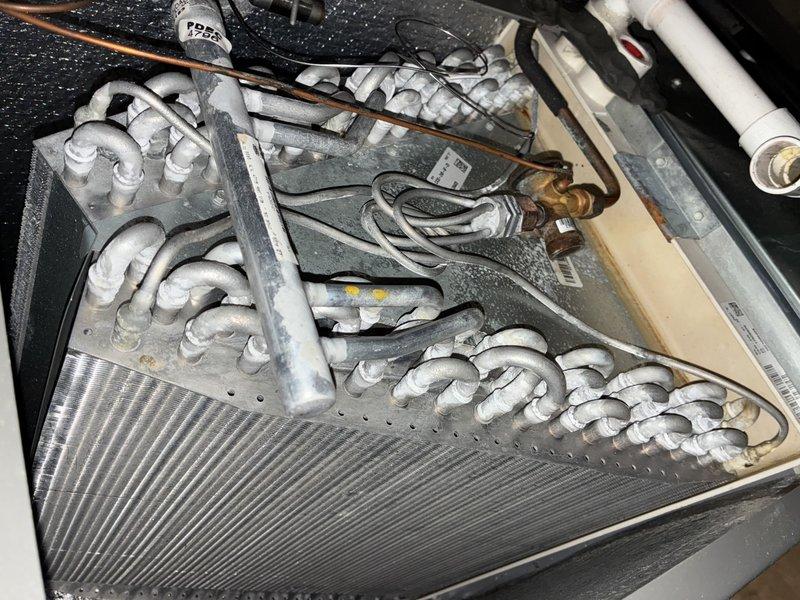 Completed comprehensive MVP AC maintenance on residential cooling system. Performed thorough inspection of evaporator coil assembly, verifying proper refrigerant line connections and insulation integrity on all white foam-wrapped copper lines. Examined control board and electrical connections within air handler cabinet, confirming all wire terminations, capacitor function, and circuit board operation. All components found operating within normal parameters with no deficiencies noted.