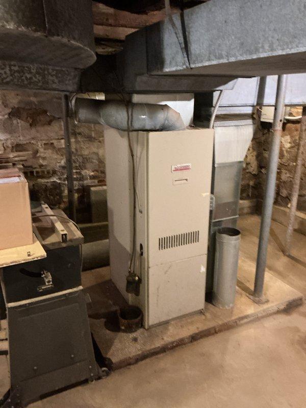 Completed full HVAC system installation including new air handler, heat pump, and humidifier in basement utility area. Reconnected supply trunk ductwork under stairs, installed all necessary metal ductwork transitions and flexible duct connections, and established proper ventilation pathways. All equipment positioned on concrete floor with secure connections to existing infrastructure, system tested and operational upon completion.