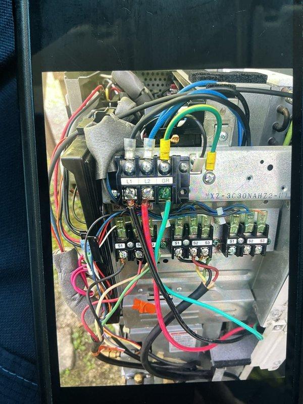 Scheduled early morning return visit to diagnose Mitsubishi unit malfunction with manufacturer technical support assistance. Accessed electrical control panel and circuit board assembly to troubleshoot system issue, documenting control board components, wiring connections, and terminal configurations for diagnostic consultation with factory technical team.