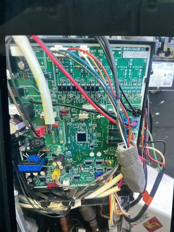 Scheduled early morning return visit to diagnose Mitsubishi unit malfunction with manufacturer technical support assistance. Accessed electrical control panel and circuit board assembly to troubleshoot system issue, documenting control board components, wiring connections, and terminal configurations for diagnostic consultation with factory technical team.