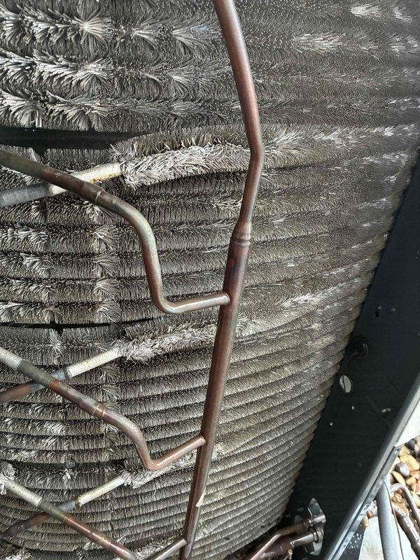 Completed MVP cooling maintenance visit on 4-year-old system. Upon inspection, discovered extensive frost and ice buildup covering the entire evaporator coil, indicating a refrigerant flow restriction or low charge condition. Documented coil condition with photos showing complete frost encasement of coil fins and copper refrigerant lines. Measured supply air temperature at 88°F, confirming insufficient cooling capacity and system malfunction. Further diagnostics required to determine root cause of freezing condition, which may include refrigerant leak, restricted metering device, low airflow, or failed components.