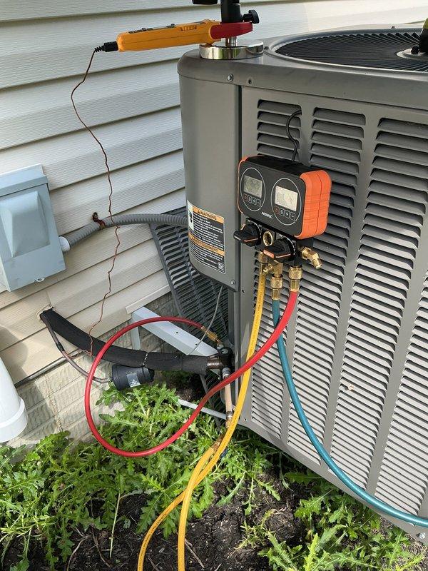 Responded to service call for a 10-year-old system making loud noises and failing to cool the home. Connected refrigerant gauges to the outdoor condenser unit to diagnose system performance and check refrigerant pressures. Customer may be interested in maintenance plan options.