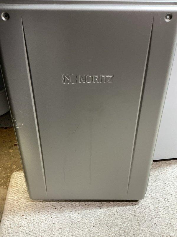 Performed routine descaling maintenance on a 2-year-old Noritz tankless water heater. Flushed the heat exchanger with descaling solution to remove mineral buildup and restore optimal heating efficiency. Unit was accessed, serviced, and reassembled with all components functioning properly upon completion.