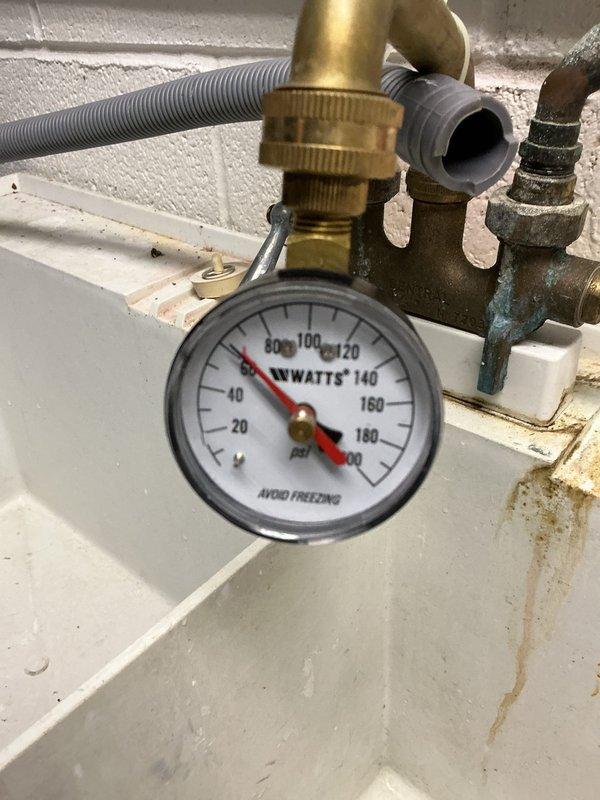 Responded to low water pressure complaint with potential water heater involvement. Upon inspection, discovered severely corroded copper supply piping with heavy verdigris and mineral buildup causing restricted water flow throughout the system. Pressure gauge reading showed 80 psi at the water heater, indicating adequate incoming pressure but compromised delivery due to deteriorated copper lines. Documented extensive corrosion on hot water supply pipes connected to water heater assembly, with flaking copper and white mineral deposits significantly reducing internal pipe diameter. Photographed corroded plumbing components and pressure relief valve assembly for service records. Advised that copper pipe replacement would be necessary to restore proper water pressure and prevent future system failure.