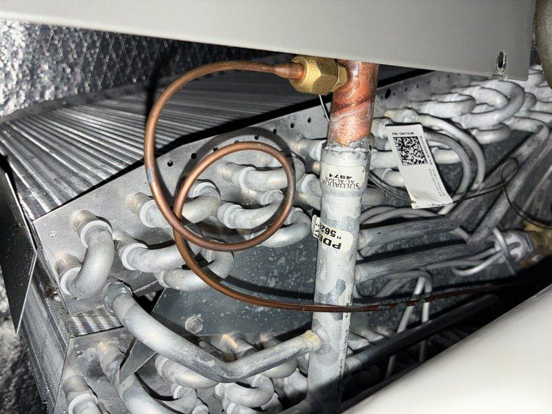 Completed routine heating maintenance on a four-year-old furnace system with no reported issues. Performed comprehensive tune-up including inspection of heat exchanger coils, refrigerant lines, and evaporator components. Documented system condition with photos showing copper refrigerant tubing connections, brass fittings, and insulated line sets in good working order.