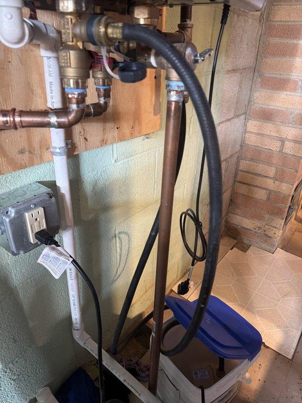 # Tankless Water Heater Flush - Rinnai Unit

Performed comprehensive flush and maintenance service on a Rinnai tankless water heater system in a 5-year-old residential property. The unit, installed in a basement utility area with proper venting and copper supply lines, was accessed and serviced according to manufacturer specifications.

## Work Performed

Isolated the tankless water heater by closing inlet and outlet service valves. Connected submersible pump and circulation hoses to the service ports using the existing isolation valve configuration. Prepared descaling solution and circulated through the heat exchanger assembly for the recommended duration to remove mineral buildup and scale deposits from the internal components.

Inspected the heat exchanger fins and burner assembly while the unit was open, verifying proper condition of the aluminum heat transfer surfaces. Examined the internal components including the fan assembly, gas valve, ignition system, and control board for an