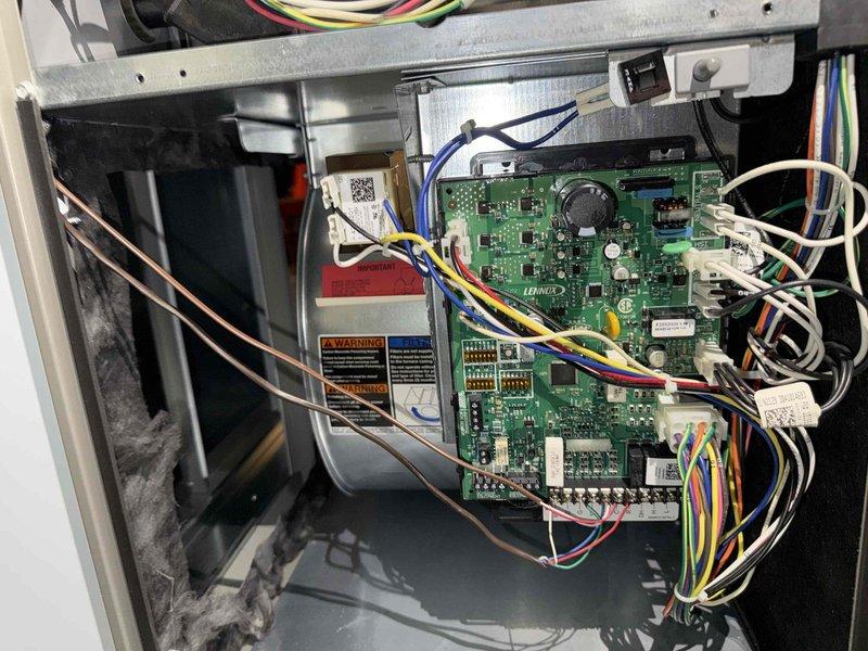Performed annual maintenance on 2-year-old gas furnace. Inspected control board, wiring connections, and internal components with access panel removed. Verified all electrical connections secure, examined circuit board for proper operation, and checked venting system including PVC intake and exhaust pipes. All components found in good working condition with no issues identified during routine maintenance inspection.