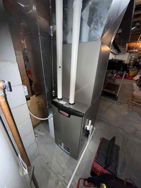 Performed annual maintenance on 2-year-old gas furnace. Inspected control board, wiring connections, and internal components with access panel removed. Verified all electrical connections secure, examined circuit board for proper operation, and checked venting system including PVC intake and exhaust pipes. All components found in good working condition with no issues identified during routine maintenance inspection.