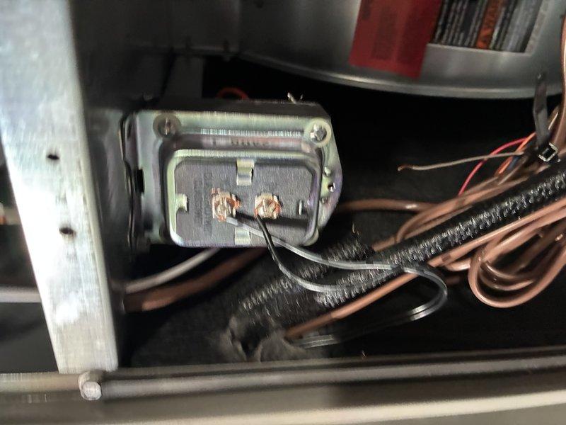 Responded to customer report of whistling sound from air conditioning system. Performed diagnostic inspection of unit, examining electrical connections, wiring terminals, and internal components. Inspected blower motor assembly, electrical control board connections, and wire harness for loose connections or vibration-related issues that could cause audible noise. Documented system condition with photos of electrical components and wiring connections for service records.