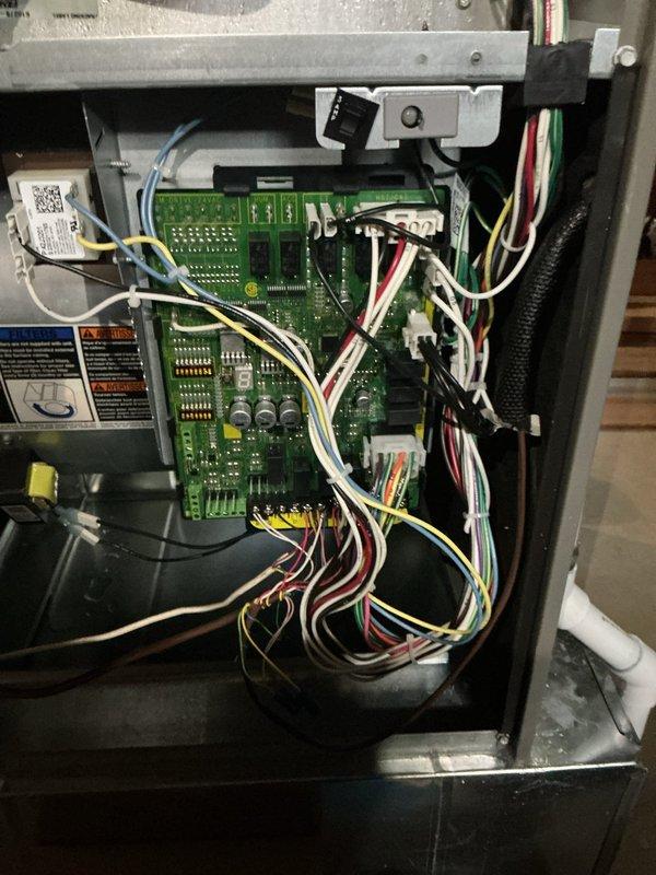 Responded to no cooling call with E201 error code displayed on 2-year-old system. Upon arrival, confirmed outdoor unit running but no airflow throughout home. Customer reported lines had frozen while away and had already defrosted unit, replaced filters, and reset breakers without resolution.

Accessed indoor air handler and inspected blower assembly and control board. E201 error code indicated blower motor failure or communication fault. Performed diagnostic testing on blower motor and found motor had failed, preventing air circulation through system. Verified all electrical connections to motor and control board were secure. Checked capacitor and confirmed outdoor unit components functioning properly, but lack of indoor airflow had caused evaporator coil to freeze initially.

Removed failed blower motor assembly from air handler cabinet. Installed new replacement blower motor with proper specifications for unit. Reconnected all wiring harnesses to motor and control board terminals. C