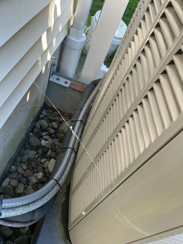 Completed comprehensive preventative maintenance on residential central air conditioning system. Performed standard AC tune-up procedures including inspection of condenser unit, verification of refrigerant levels, electrical connections check, and system operational testing. Exterior condenser unit showed moderate dust and debris accumulation on intake screen, which was cleaned to restore optimal airflow. Inspected condensate drainage system including PVC discharge lines and flexible drain hose for proper function and clearance. All components found operating within normal parameters with no deficiencies noted. System confirmed functioning properly with no repairs required.