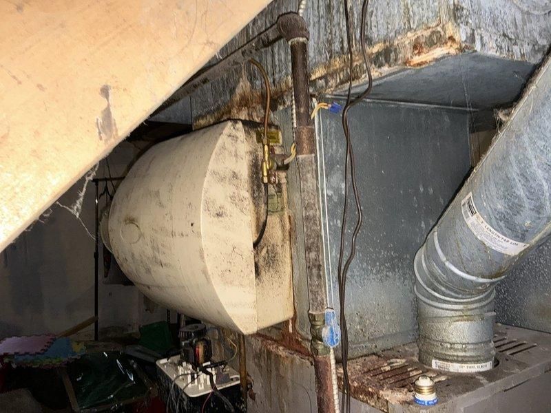 Conducted comprehensive assessment of existing HVAC system in crawl space for equipment replacement estimate. Documented current furnace and air conditioning unit conditions, including heavily corroded copper piping connections, aging water heater, deteriorated ductwork, and compromised structural elements in confined utility space. Provided detailed photographic documentation and replacement recommendations for complete system upgrade scheduled for installation.