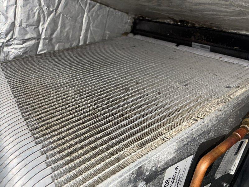 Completed furnace tune-up on 9-year-old unit. Performed comprehensive inspection of evaporator coil assembly, noting moderate dust and debris accumulation on aluminum fins with minor discoloration consistent with normal operational wear. Coil structure remains intact and functional with no signs of damage or refrigerant leaks observed on copper line connections.