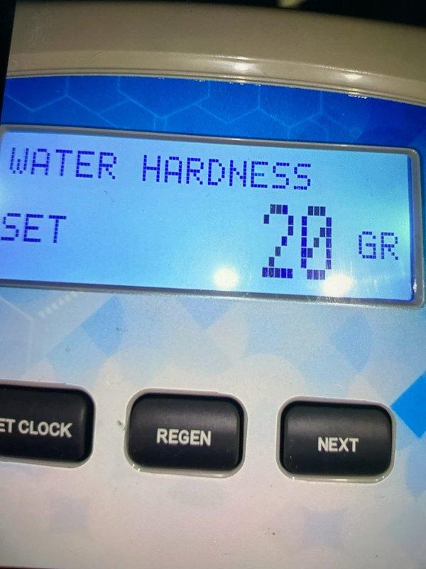 Delivered and loaded six bags of water softener salt to residential water conditioning system. Verified system operation and checked water hardness settings, which displayed 28 grains on the digital control panel. Replenished salt reservoir with granular salt media to ensure continued proper function of the water softening unit.