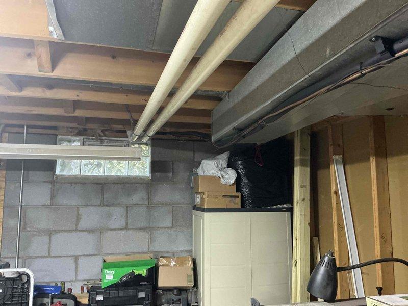 Conducted HVAC system replacement consultation for a 13-year-old air conditioning unit that had previously required repair work exceeding typical maintenance costs. Assessed existing furnace and air handler installation in basement utility area, documenting current system configuration including PVC condensate drainage, ductwork connections, and equipment positioning. Presented replacement options and discussed available manufacturer rebates, energy efficiency benefits of newer systems, and loyalty program credits applicable toward new equipment installation.