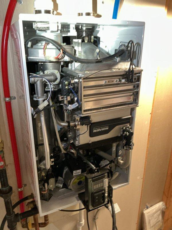 Performed descaling maintenance on an 11-year-old Navien NPE-240A tankless natural gas water heater. Flushed the heat exchanger system to remove mineral buildup and restore optimal performance, completing the service during the confirmed morning appointment window.
