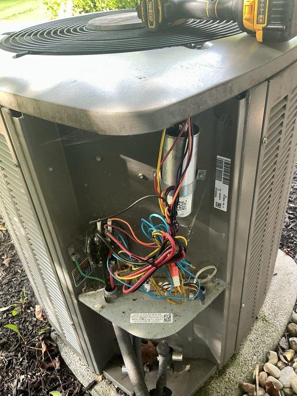 Performed scheduled maintenance on a 9-year-old Lennox air conditioning system. Inspected outdoor condensing unit, accessed internal components including capacitor and electrical connections, verified proper wiring configuration, and examined refrigerant lines to ensure system operational readiness for the cooling season.