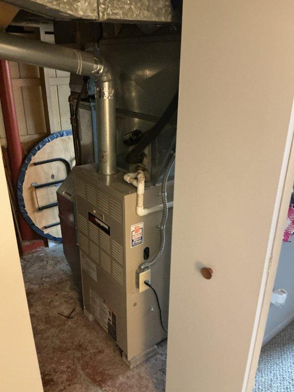 # HVAC Install - Complete System

Completed installation of a new 80% efficiency furnace and air conditioning system in residential property. Installed beige-cased furnace unit in utility closet with proper clearances and mounting on concrete pad. Connected galvanized metal supply plenum and ductwork extending vertically from furnace cabinet to existing distribution system. Routed PVC condensate drain and vent piping per manufacturer specifications. Installed flexible insulated ductwork connections to air handler components. Completed all electrical connections including control wiring and power supply. Verified proper airflow through supply and return duct systems. Connected outdoor condensing unit to indoor coil with refrigerant lines. Tested system operation including heating and cooling cycles, airflow measurements, and safety controls. System operating within manufacturer specifications and ready for service.