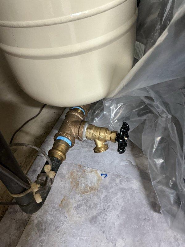 Installed a new 40-gallon Bradford White water heater with 6-year manufacturer warranty in residential utility room. Reused existing ball valve and expansion tank already present on the line after the meter. Removed, serviced, and reinstalled the boiler drain on the main water line using pipe thread sealant tape and dope to eliminate existing drip leak. All copper piping connections completed at top of unit with proper fittings, and installation verified for proper operation with adequate service access maintained around equipment.