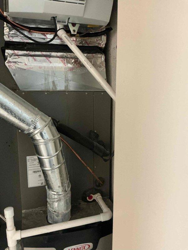 Completed full humidifier system replacement including installation of new AprilAire 700 whole-house humidifier unit with digital control panel. Removed existing humidifier assembly and replaced all associated components including mounting hardware, water supply lines, drainage system, and electrical connections. Integrated new humidifier into existing HVAC ductwork, secured all duct connections with foil tape, verified proper electrical wiring and conduit routing, and programmed digital control unit. System tested and confirmed operational with proper humidification output to supply plenum.