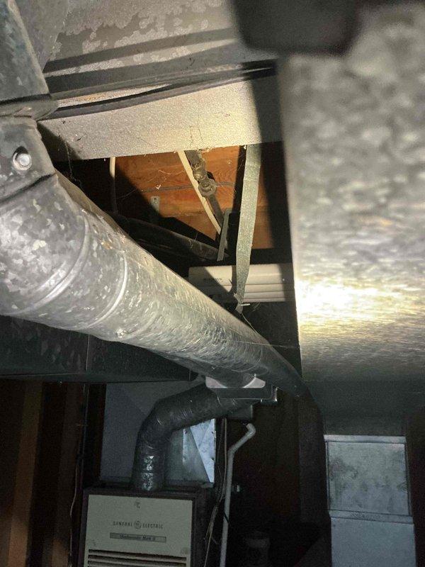 Conducted on-site assessment for Kohler generator installation in basement utility area. Evaluated existing electrical infrastructure, including main service panel location and available space for generator placement and associated equipment. Documented installation site conditions, including exposed ceiling joists, concrete block walls, and current HVAC ductwork routing to determine optimal generator positioning and required electrical connections for automatic transfer switch integration.