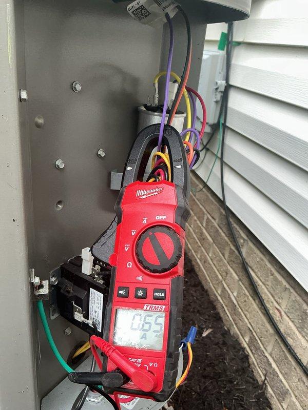 Completed MVP recurring cooling maintenance visit on residential HVAC system. Inspected and tested electrical components including disconnect panel, contactor, and Edison brand fuses, which were found to be in good condition with no signs of corrosion or damage. Performed amperage readings using clamp meter, recording 0.55 amps on measured circuit. All electrical connections, wiring, and capacitor verified secure and functioning properly. System operational and ready for continued service.