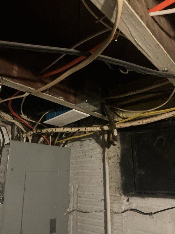 Completed comprehensive electrical safety repairs throughout the residence, addressing multiple code violations and hazardous conditions. Installed four-gang blank plate on exposed junction box above main panel, secured loose MC cable near furnace with proper junction box and cover, and removed damaged pull chain fixture from floor joists, replacing with code-compliant box and cover. Replaced standard outlets with GFCI protection in bedroom and front porch locations for enhanced safety, installed proper blank cover on fiberglass 4x4 box near furnace, and corrected bathroom outlet installation with appropriate spacers and new cover plate. All junction boxes properly secured and covered per NEC requirements, eliminating exposed wiring hazards in basement utility areas.