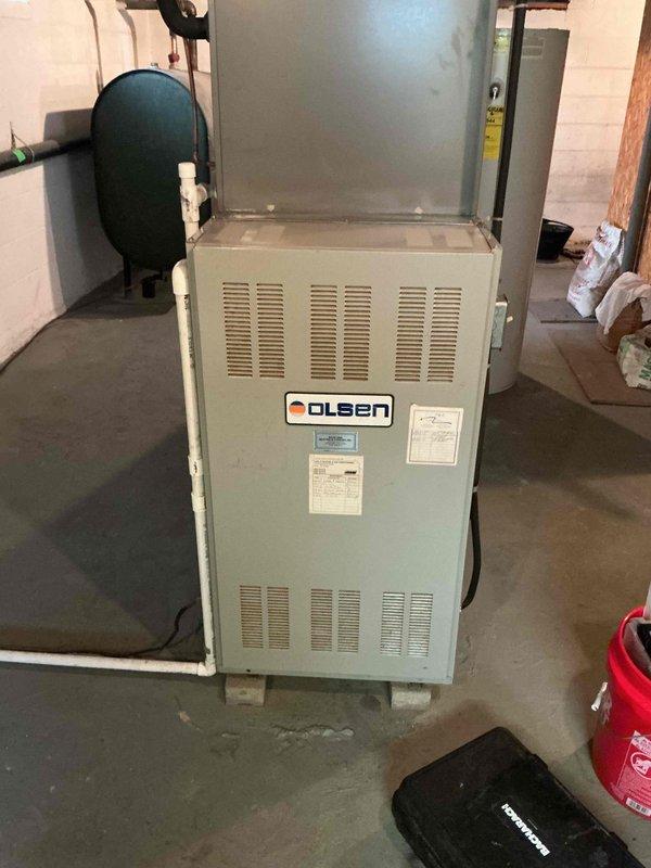 Completed comprehensive tune-up on 20+ year old Olsen oil furnace system. Performed standard maintenance protocol including inspection of all major components, burner assembly cleaning, and thorough vacuuming of debris from tight spaces throughout the unit and surrounding mechanical room area as requested. System operating properly upon completion with all safety controls verified functional.