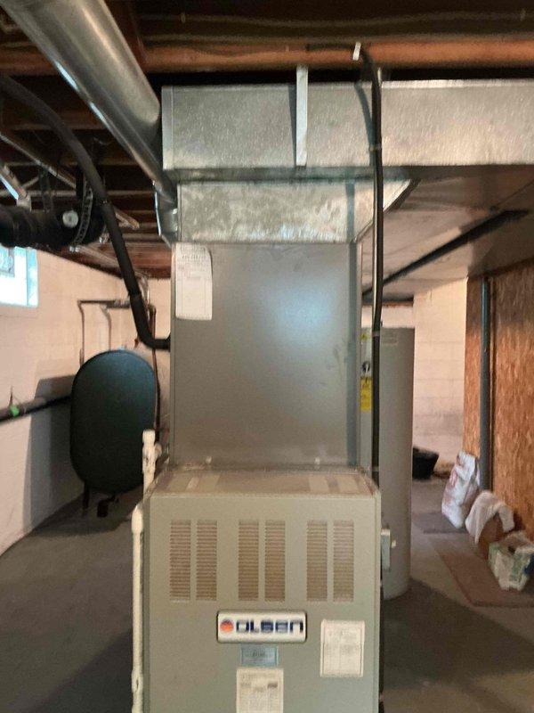 Completed comprehensive tune-up on 20+ year old Olsen oil furnace system. Performed standard maintenance protocol including inspection of all major components, burner assembly cleaning, and thorough vacuuming of debris from tight spaces throughout the unit and surrounding mechanical room area as requested. System operating properly upon completion with all safety controls verified functional.