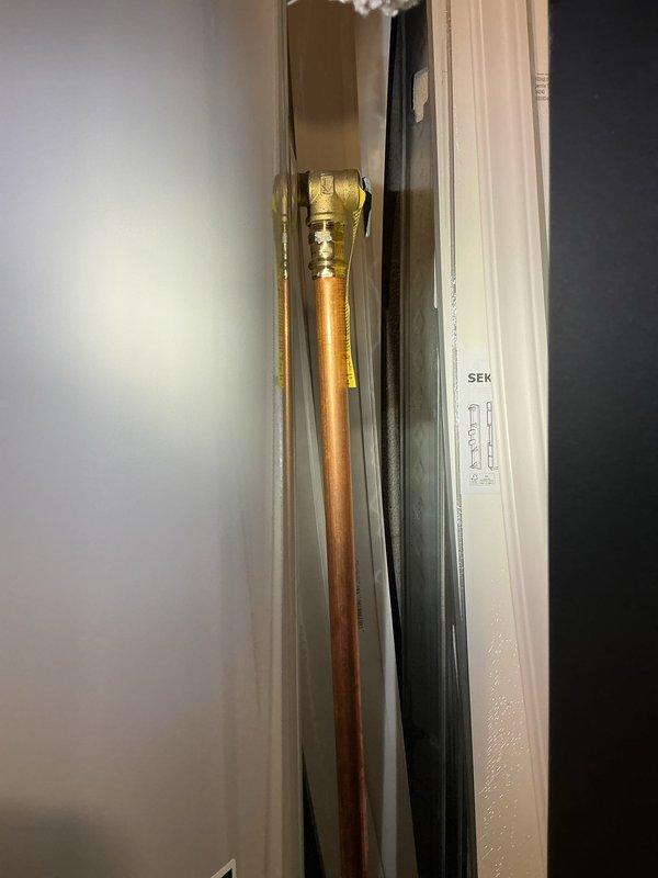 Responded to service call for reported hot water tank leak. Upon arrival, performed thorough inspection of plumbing system and identified source of water leakage. Documented existing copper piping with brass fittings in wall cavity and overhead copper pipe installation in drop ceiling area showing signs of oxidation and age-related deterioration. Assessed leak location and provided customer with findings and repair recommendations.