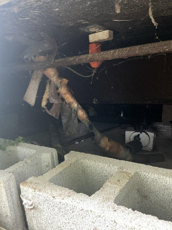 Conducted site assessment of crawl space for water pipe heat trace cable installation. Inspected existing plumbing infrastructure, noting corroded horizontal pipe requiring freeze protection. Evaluated structural access points, concrete block foundation, and clearances for proper heat tape routing. Documented current conditions of exposed piping, deteriorated insulation, and crawl space environment. Provided detailed quote for heat trace cable installation including materials and labor requirements to prevent freeze damage to water supply lines.