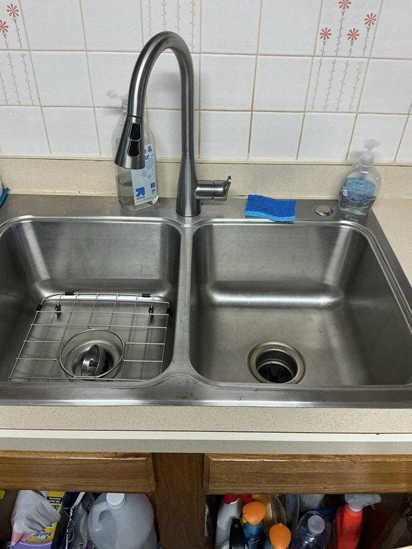 Responded to service call for slow draining kitchen sink and three bathroom drains experiencing backup issues. Upon arrival, performed diagnostic assessment of all affected fixtures. Kitchen sink showed signs of drainage obstruction with double-basin stainless steel configuration requiring attention. Bathroom sink displayed evidence of severe backup conditions with extensive staining throughout basin and countertop surfaces indicating prolonged drainage problems.

Cleared blockages from main drain lines servicing kitchen and bathroom fixtures using appropriate drain cleaning equipment. Restored proper water flow and drainage function to all affected sinks. Verified successful clearance by testing each fixture for adequate drainage speed and confirming no remaining backup conditions. All drains now operating within normal parameters.