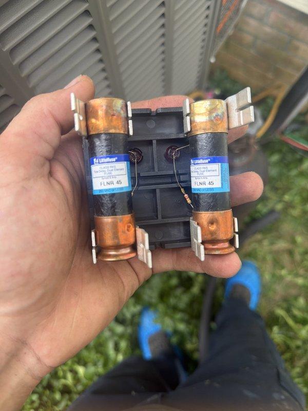 # HVAC Install - A/C & Coil

Completed installation of new air conditioning system and evaporator coil at residential property. Upon initial assessment, discovered severely burnt and oxidized electrical fuses in the outdoor disconnect, indicating previous electrical stress or overheating condition that likely contributed to system failure. Removed damaged fuses and replaced with properly rated components to ensure safe electrical operation.

Installed new condensing unit with associated refrigerant line set, including copper suction and liquid lines with proper insulation. Ran new electrical whip from disconnect box to unit using gray flexible conduit. Connected and secured all refrigerant piping with brass fittings, ensuring proper brazing and leak-free connections. Installed lineset with appropriate support and protection through landscaped areas.

Mounted outdoor disconnect box on concrete pad with proper clearances. Applied service labels and documentation to equipment per code req