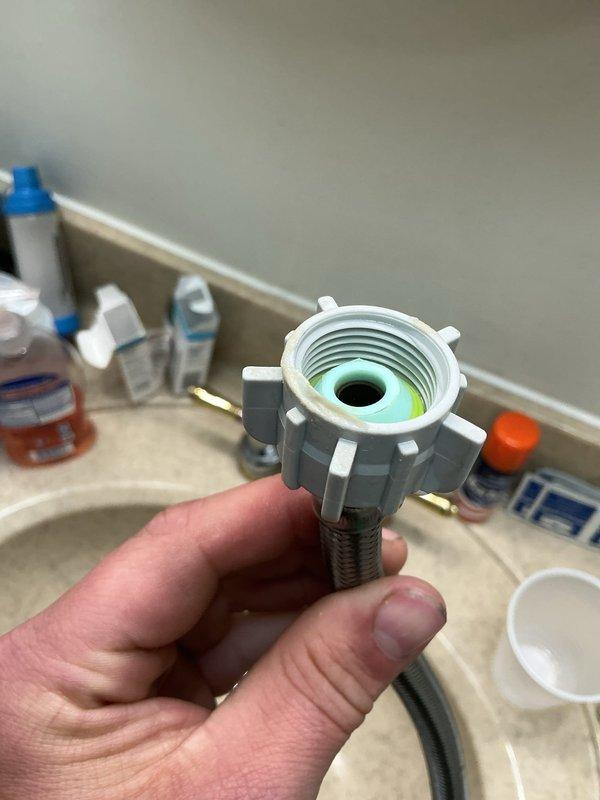 Responded to emergency call for bathroom flooding caused by failed toilet shut-off valve. Upon arrival, found water actively spraying from the valve connection point at the wall supply line. Immediately shut off water supply to the toilet to stop the active leak and prevent further water damage. Removed the defective shut-off valve assembly, which showed signs of internal seal failure. Installed new angle stop valve with fresh supply line connection. Tested the new valve installation for proper operation and verified no leaks at connection points. Restored water supply and confirmed toilet fill valve functioning correctly with no water spray or seepage.