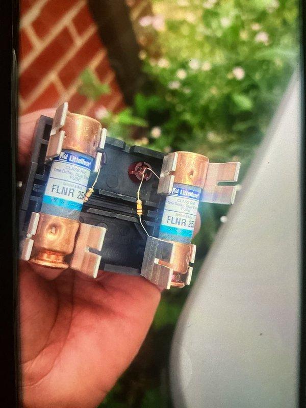 Performed comprehensive cooling system maintenance on outdoor HVAC unit. Removed and inspected heavily clogged condenser coil showing significant accumulation of dirt, dust, and debris that was restricting airflow and reducing system efficiency. Cleaned condenser coil thoroughly to restore proper heat transfer capabilities. Inspected and tested electrical components including 25-amp Littelfuse FLNR fuses, confirming proper operation and secure connections. Verified all electrical connections and conduit were intact and functioning correctly. System restored to optimal operating condition with improved airflow and cooling performance.