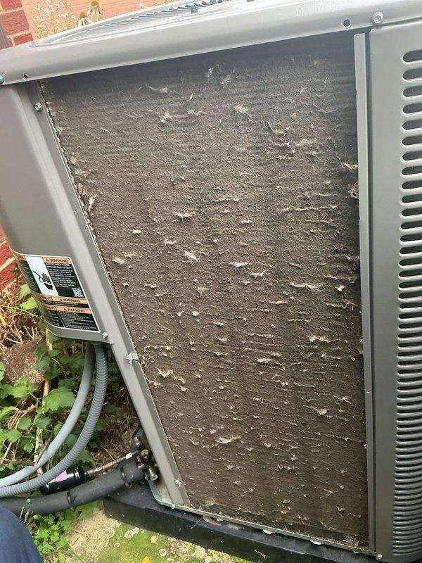 Performed comprehensive cooling system maintenance on outdoor HVAC unit. Removed and inspected heavily clogged condenser coil showing significant accumulation of dirt, dust, and debris that was restricting airflow and reducing system efficiency. Cleaned condenser coil thoroughly to restore proper heat transfer capabilities. Inspected and tested electrical components including 25-amp Littelfuse FLNR fuses, confirming proper operation and secure connections. Verified all electrical connections and conduit were intact and functioning correctly. System restored to optimal operating condition with improved airflow and cooling performance.
