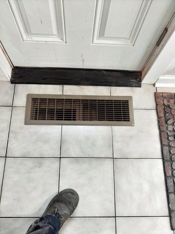Relocated return air vent from wall-mounted position to floor installation in front of doorway entrance. Cut through ceramic tile flooring to accommodate new floor register placement. Performed PVC repipe work connecting to both furnace and air conditioning unit, installing approximately 20 feet of 3/4-inch PVC piping to complete the ductwork relocation and ensure proper system operation.