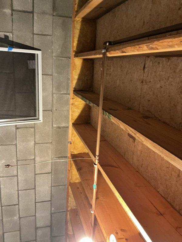 Conducted on-site evaluation of existing 40-gallon natural gas water heater located in basement utility area. Inspected unit manufactured in 2013 and documented current installation conditions including proximity to wooden shelving structure and concrete block foundation walls. Assessed plumbing connections, venting requirements, and clearance specifications for potential replacement. Photographed equipment specifications, safety labels, and surrounding work area to prepare comprehensive replacement estimate. Customer available for consultation during standard business hours with advance notification requested.
