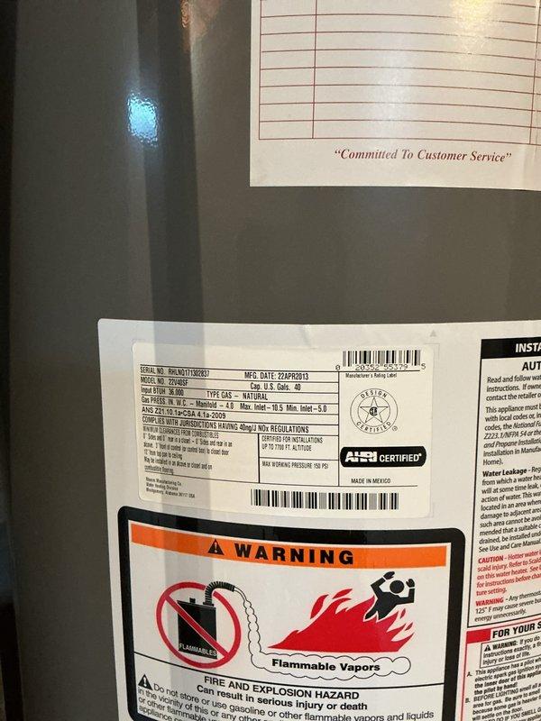 Conducted on-site evaluation of existing 40-gallon natural gas water heater located in basement utility area. Inspected unit manufactured in 2013 and documented current installation conditions including proximity to wooden shelving structure and concrete block foundation walls. Assessed plumbing connections, venting requirements, and clearance specifications for potential replacement. Photographed equipment specifications, safety labels, and surrounding work area to prepare comprehensive replacement estimate. Customer available for consultation during standard business hours with advance notification requested.