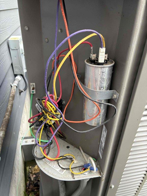 Completed MVP AC maintenance on cooling system. Performed electrical diagnostics using clamp meter, recording amperage reading of 42.1 amps to verify compressor operation within manufacturer specifications. Inspected capacitor and associated electrical connections, noting weathering on component surface but confirming all wire terminations secure at terminal blocks.