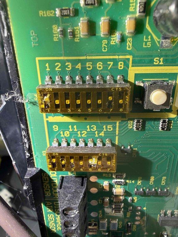 Completed maintenance inspection on 8-year-old air conditioning system with dual outdoor units. Inspected evaporator coil showing normal condensation patterns and examined control board with DIP switch configurations, verifying all electronic components and system settings were functioning properly.