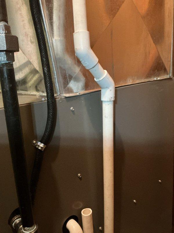 Completed conversion from oil-fired heating system to high-efficiency 90% propane furnace. Installed new furnace unit with PVC condensate drain system featuring multiple elbow configurations and proper trap assembly. Routed exhaust flue piping and fresh air intake through garage to exterior termination points per specifications. Ran new propane gas supply line from meter through garage to furnace location using MegaPress fittings for secure connections. Installed black insulated refrigerant lines alongside drainage system with metal clamps for proper support. All venting, gas piping, and drainage systems tested and verified operational upon completion.