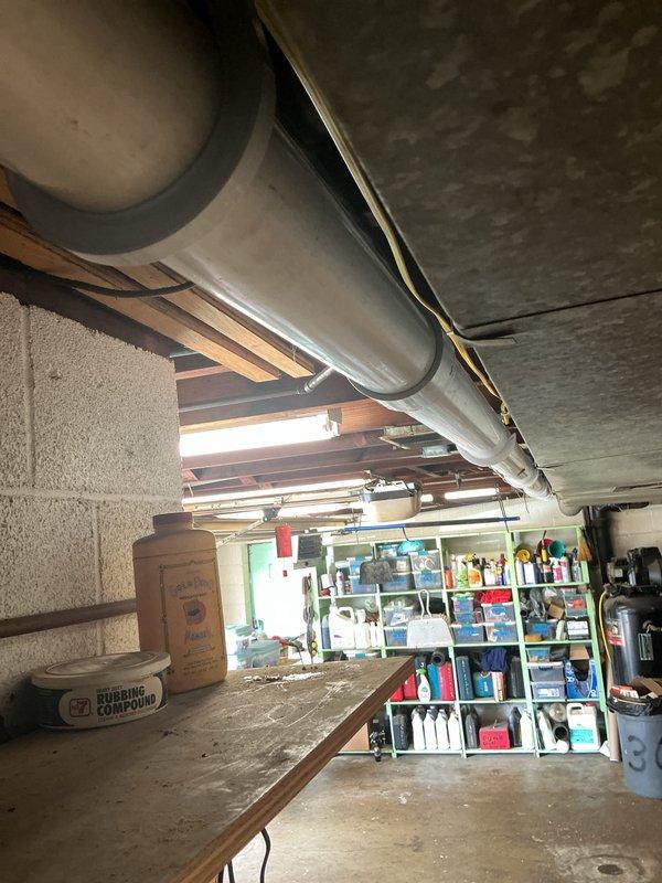 Completed conversion from oil-fired heating system to high-efficiency 90% propane furnace. Installed new furnace unit with PVC condensate drain system featuring multiple elbow configurations and proper trap assembly. Routed exhaust flue piping and fresh air intake through garage to exterior termination points per specifications. Ran new propane gas supply line from meter through garage to furnace location using MegaPress fittings for secure connections. Installed black insulated refrigerant lines alongside drainage system with metal clamps for proper support. All venting, gas piping, and drainage systems tested and verified operational upon completion.