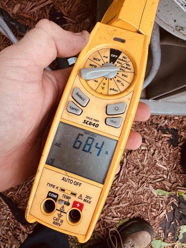 Responded to no cooling complaint on 6-year-old air conditioning system. Upon inspection, found compressor experiencing abnormally high inrush current reading of 68.4 amps, indicating compressor failure. Verified electrical connections at contactor and terminal block were secure with proper wire terminations. System unable to produce cold air due to failed compressor. Recommended compressor replacement or full condenser unit replacement based on age and repair cost considerations.
