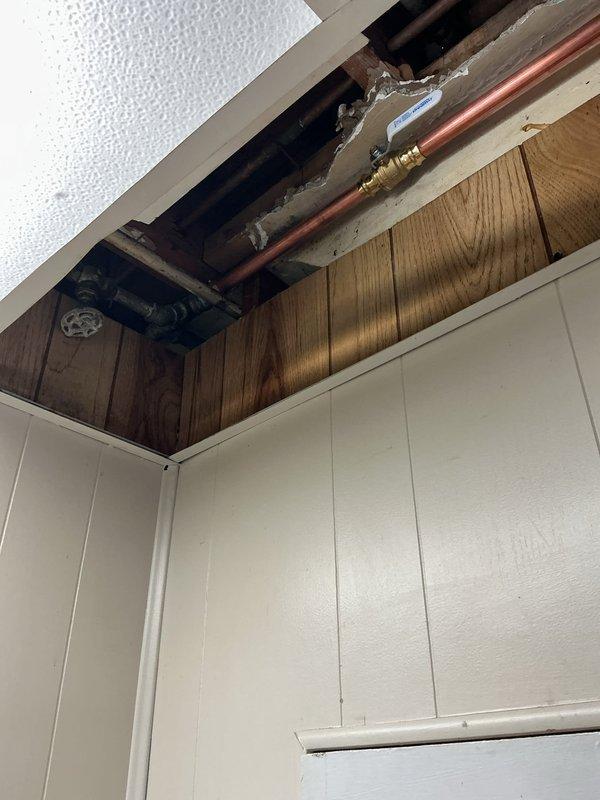 Installed new boiler drains and necessary shutoff valves on existing copper supply lines in the laundry area. Replaced visible galvanized piping sections with appropriate adapters to transition to copper, ensuring proper flow control and system isolation capabilities. Opened ceiling access to complete upper connections and secured all new fittings to code specifications.