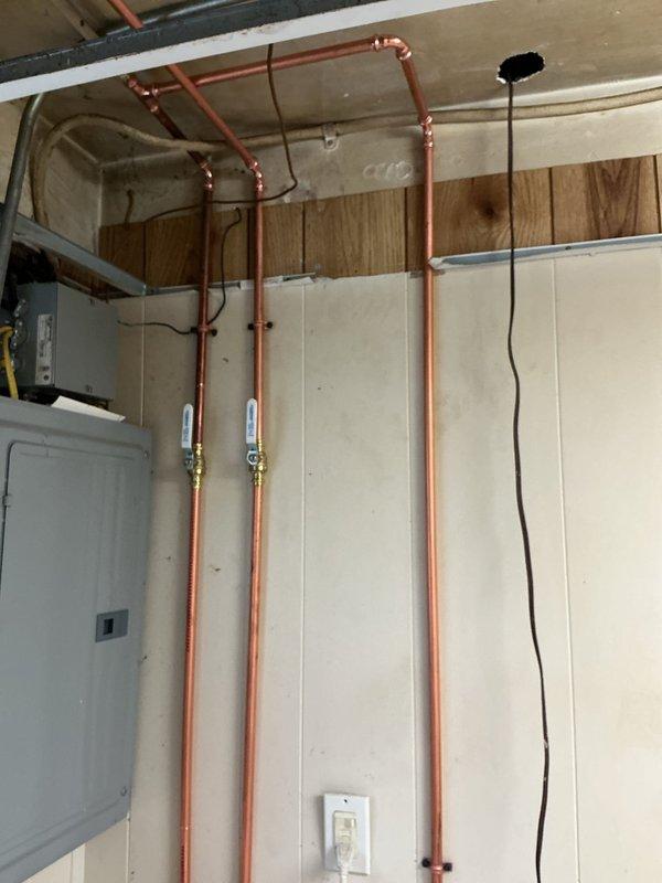 Installed new boiler drains and necessary shutoff valves on existing copper supply lines in the laundry area. Replaced visible galvanized piping sections with appropriate adapters to transition to copper, ensuring proper flow control and system isolation capabilities. Opened ceiling access to complete upper connections and secured all new fittings to code specifications.