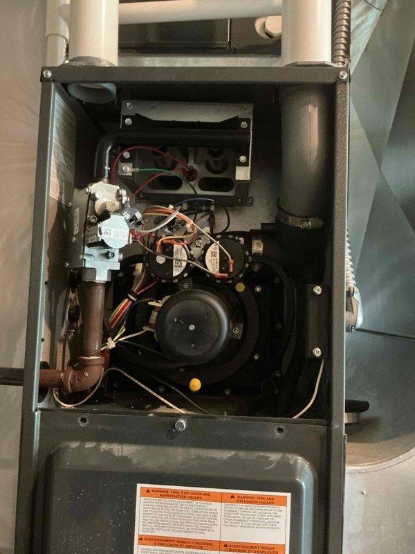 Responded to no-cooling complaint on 5-year-old residential air conditioning system. Upon arrival, performed comprehensive diagnostic evaluation of Goodman HVAC system. Inspected outdoor condensing unit and noted white residue on exterior casing with no evidence of frost formation or refrigerant freezing. Removed furnace access panel to examine indoor air handler components, blower motor operation, and electrical connections. Verified gas valve assembly, heat exchanger condition, and all wiring terminations were secure and functioning properly. System showed no immediate mechanical failures or refrigerant leaks. Documented equipment condition with photographs for service records. Provided second opinion assessment as requested.